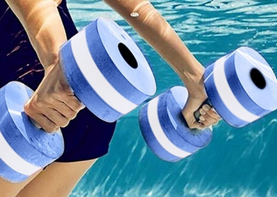 Water aerobics student uses water weights in the pool.